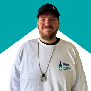 Todd Stanton, Kind Home Painting project manager, headshot in a Kind Home branded shirt and cap